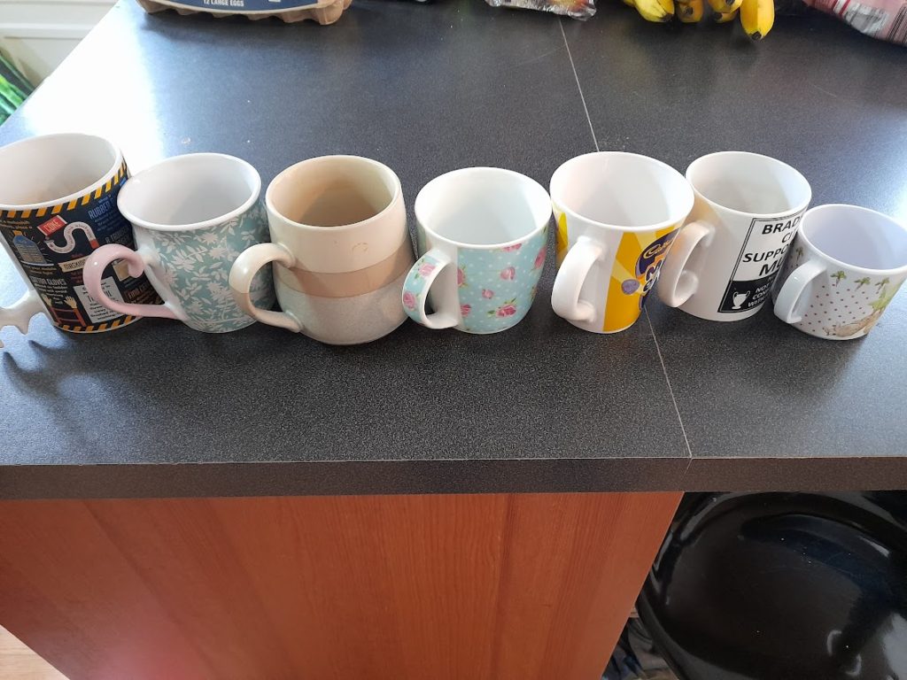 seven mugs arranged in order of size