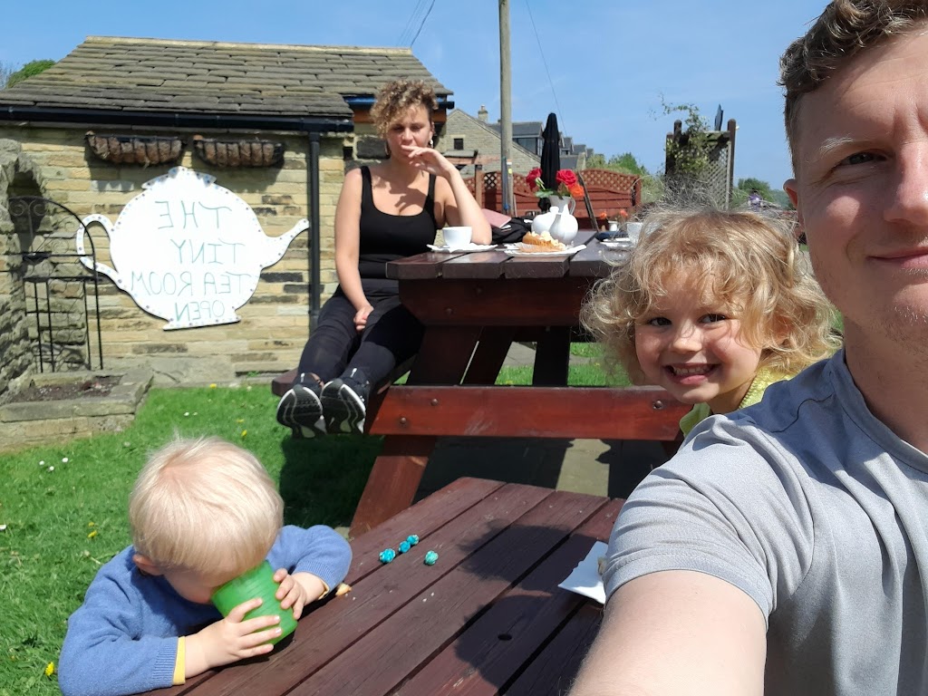 Family sat outside a cafe in the sun