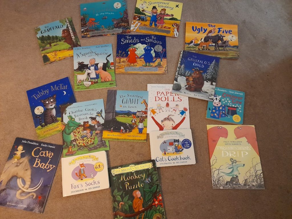 Several Julia Donaldson books spread out on a carpet floor.