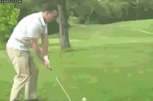 A man hits a golf ball and it rebounds off a tree and hits him.