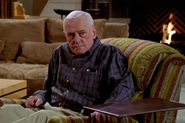 Martin Crane from the TV show 'Frasier', sat in his armchair with a stern face.